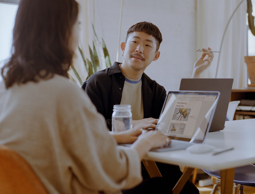 An adviser talking a client through their financial plan at a desk