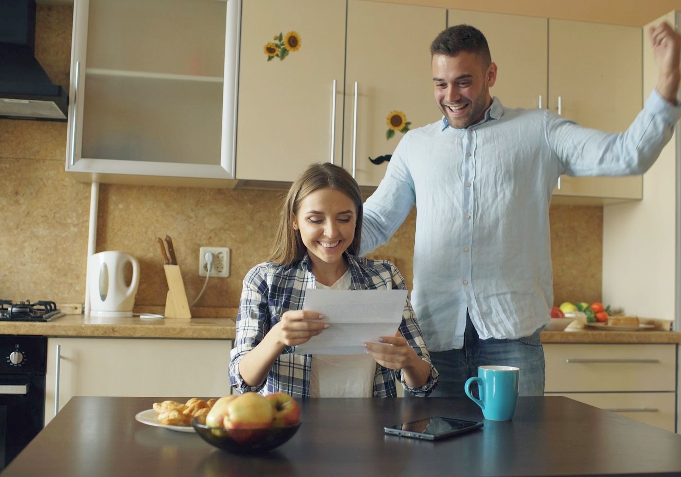 A couple reading a letter together at home