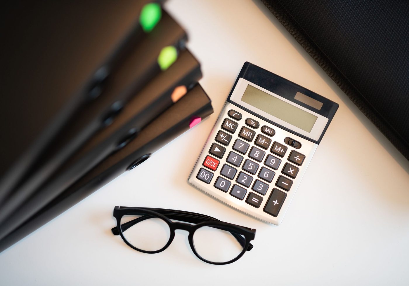 Calculator and reading glasses on a client's paperwork