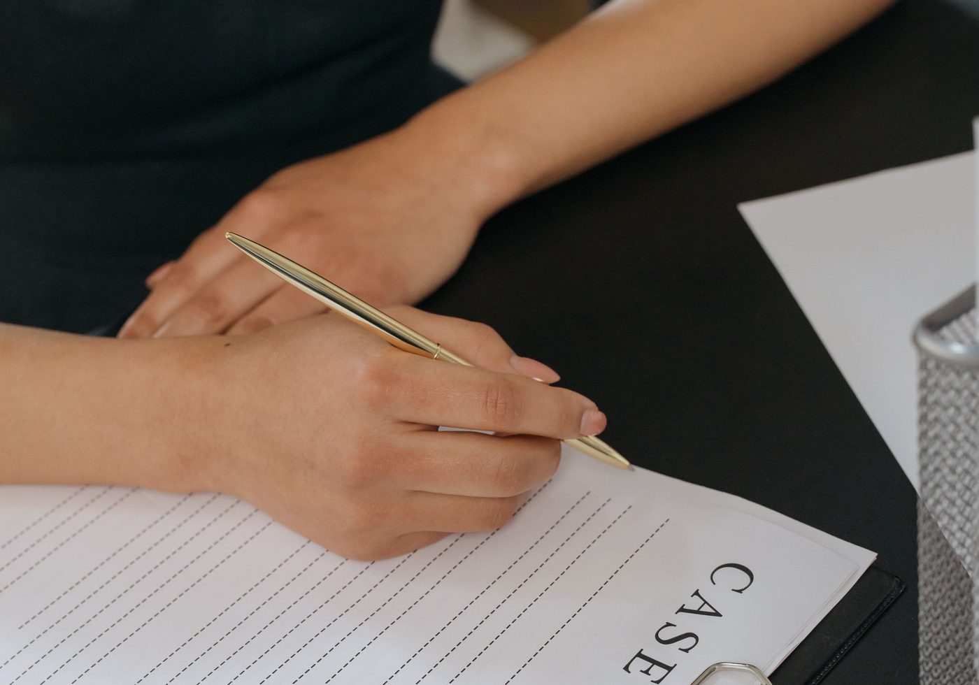 A cash book and pen on a desk