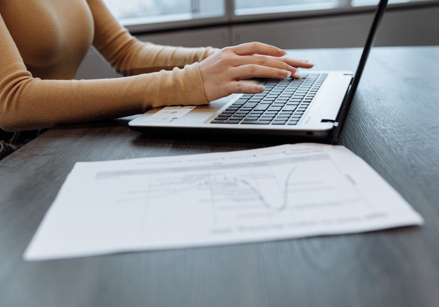 A chart and a laptop on a desk
