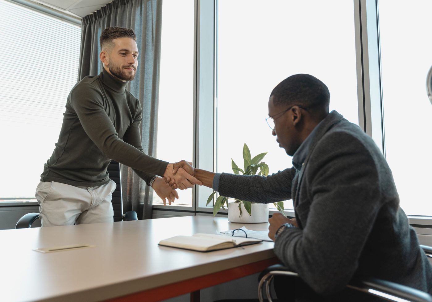 A business owner shaking hands across a desk