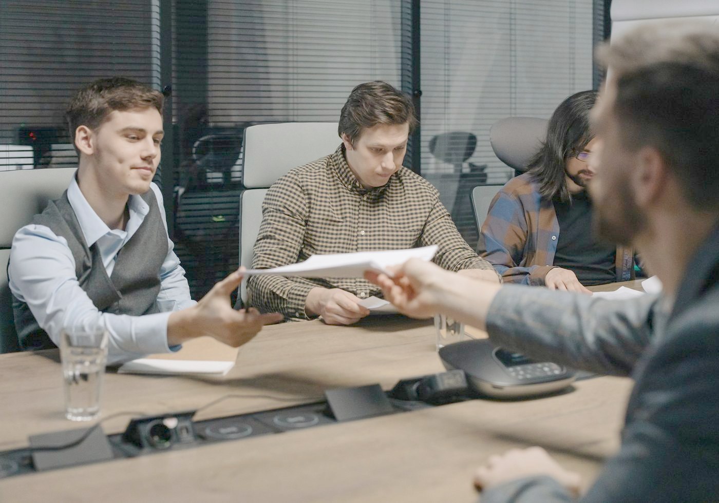 An accountant handing a client a document