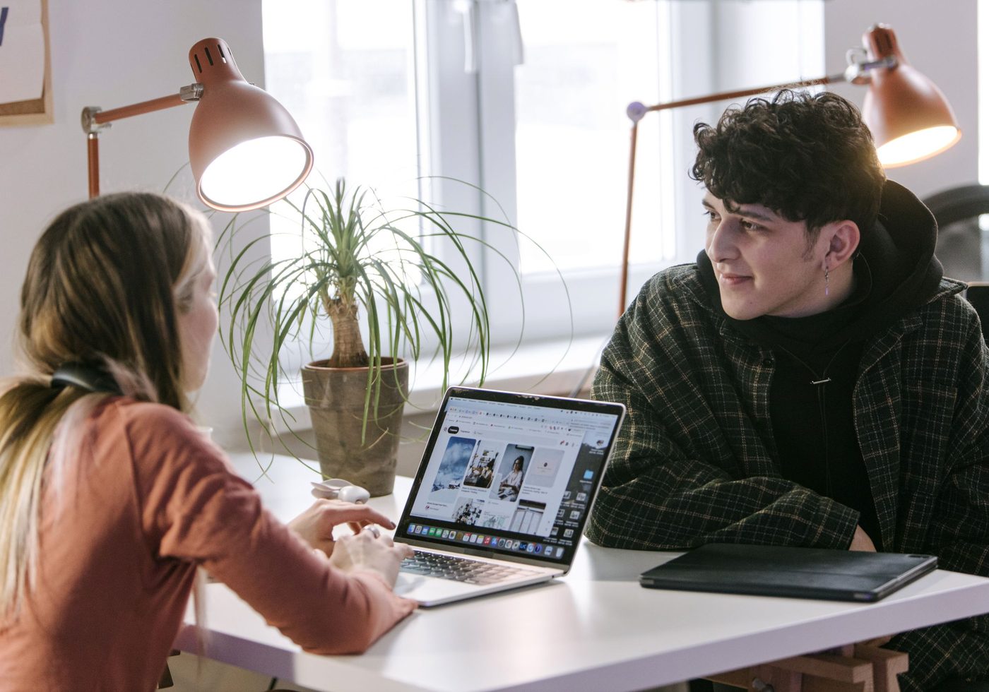 Two people reviewing the partner portal on a laptop
