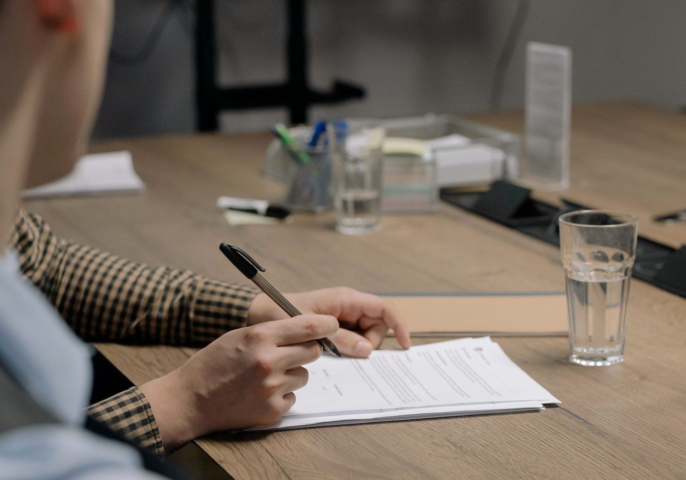 An engagement letter being signed at a table